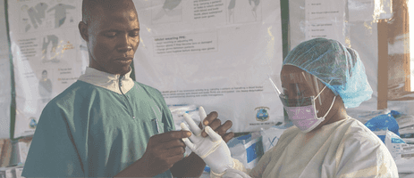 Healthcare worker putting on personal protective equipment
